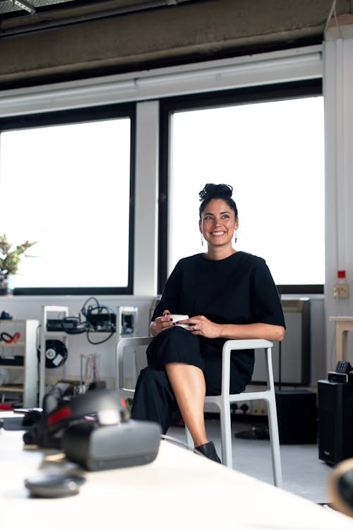 Free Portrait of Woman Sitting on Chair Stock Photo