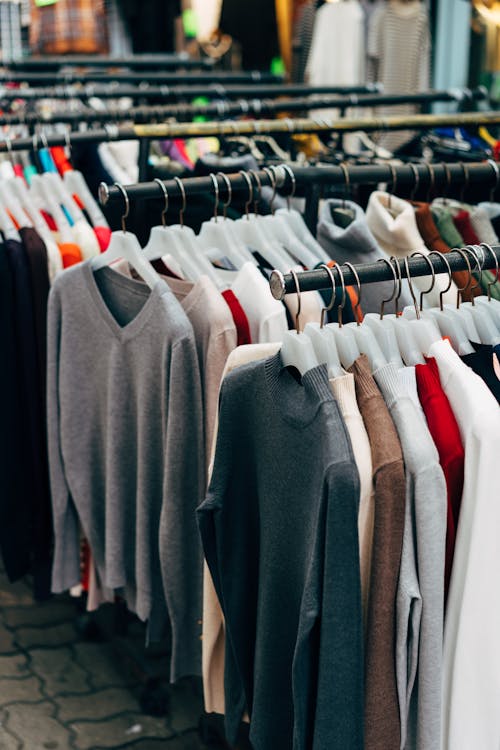 Free Clothes on Hangers Hanging on Clothing Racks Stock Photo