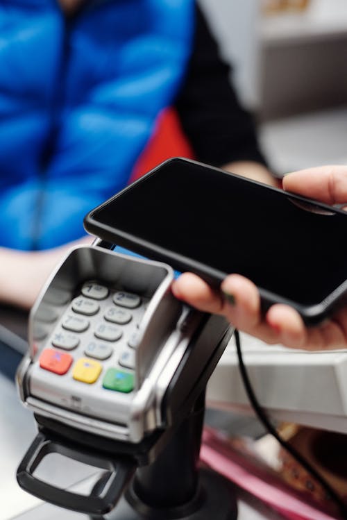 Free Making a Payment with a Smartphone Stock Photo