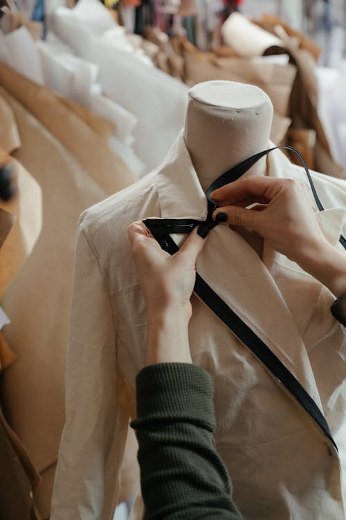 Free Person in White Dress Shirt and Black Necktie Holding White Suit Jacket Stock Photo