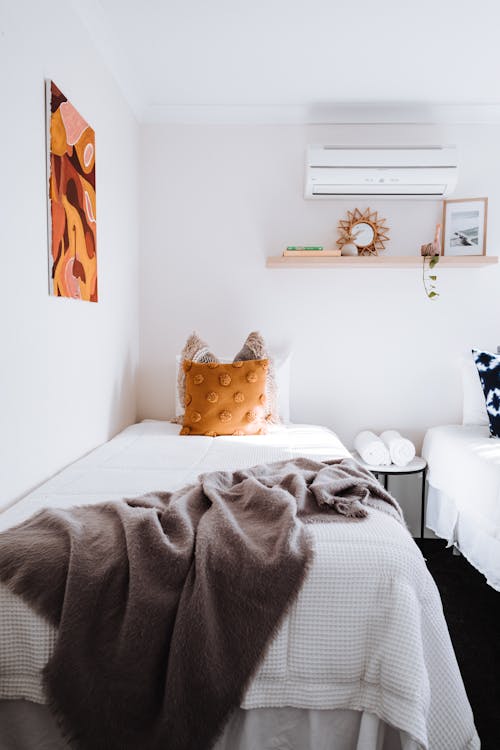 Free Light bedroom with cushions on bed Stock Photo