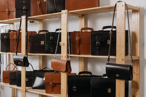 Free Leather Bags on Wooden Shelves Stock Photo