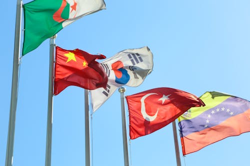 Free Photograph of Flag Poles with Different Country Flags Stock Photo