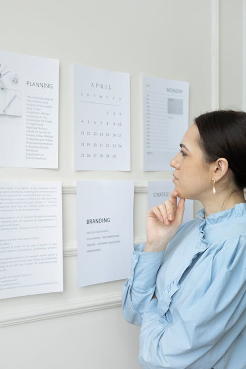 Free A Woman Thinking while Looking at Paper Stock Photo